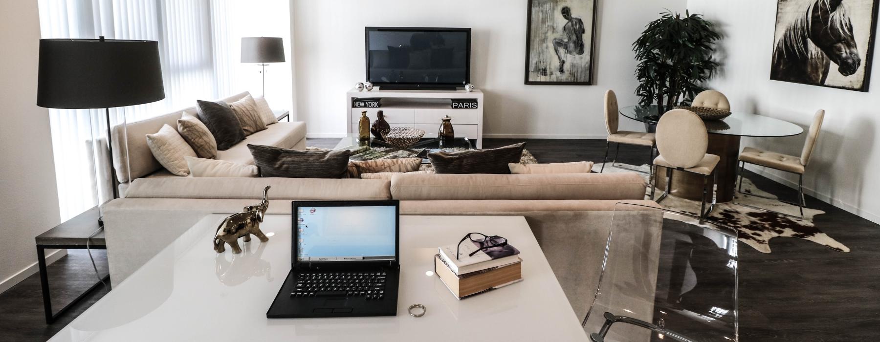a living room with a laptop on a table
